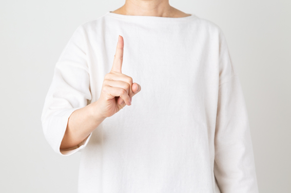 人差し指を立てている女性
